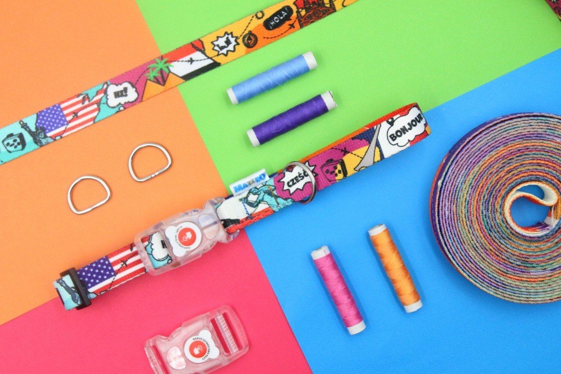 4. Flat lay of Matteo LED collar with colorful print, threads, and D-rings on multicolored background