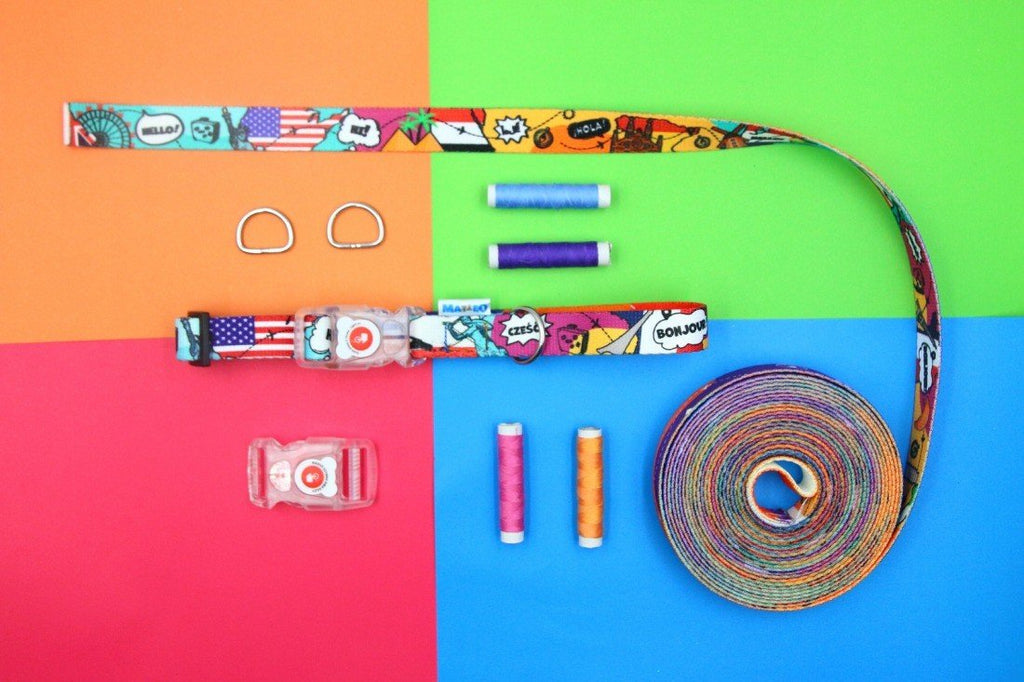 4. Flat lay of Matteo LED collar with colorful print, threads, and D-rings on multicolored background