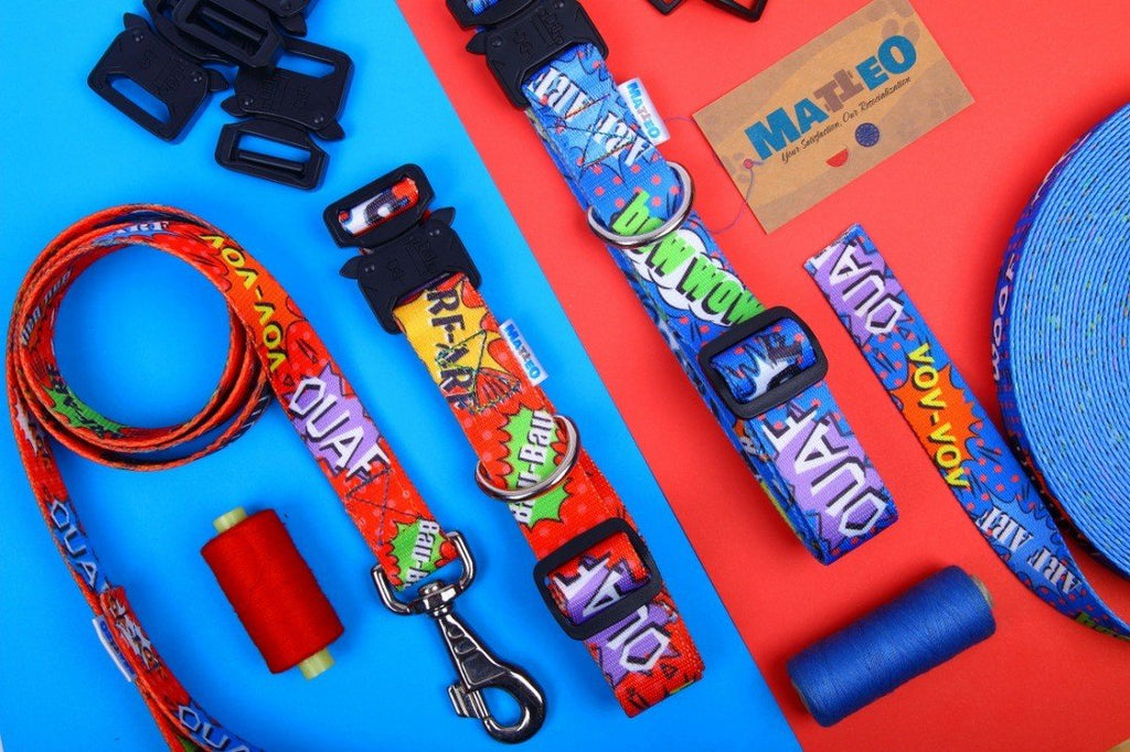 4. Flat lay of blue graffiti dog collar and accessories, including buckles and threads, on a red and blue background, showcasing colorful comic-style design.
