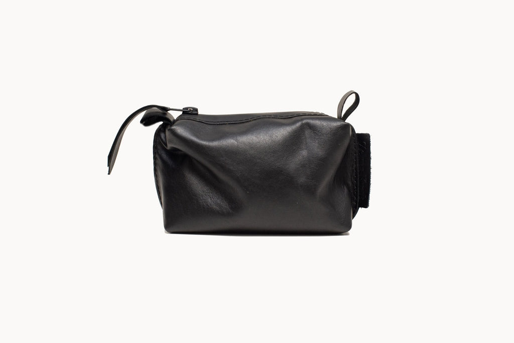 5. Side view of Zelma Kraft black leather cosmetic bag, highlighting natural cattle leather material