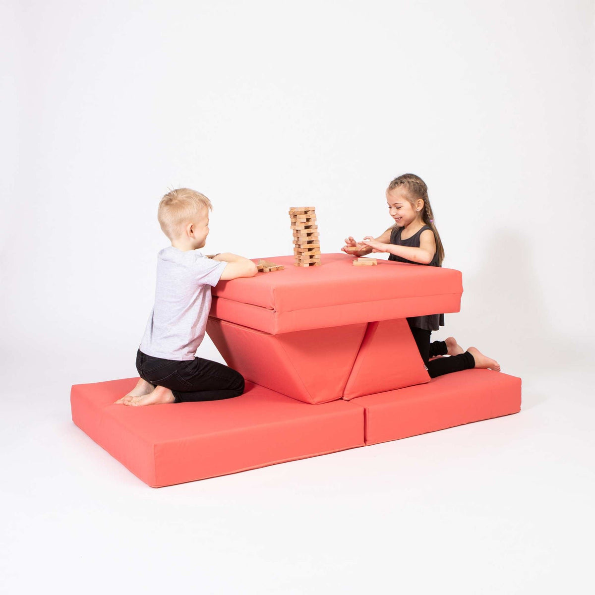 4. Two children playing on coral activity play mattress set arranged as a table and seats in a studio