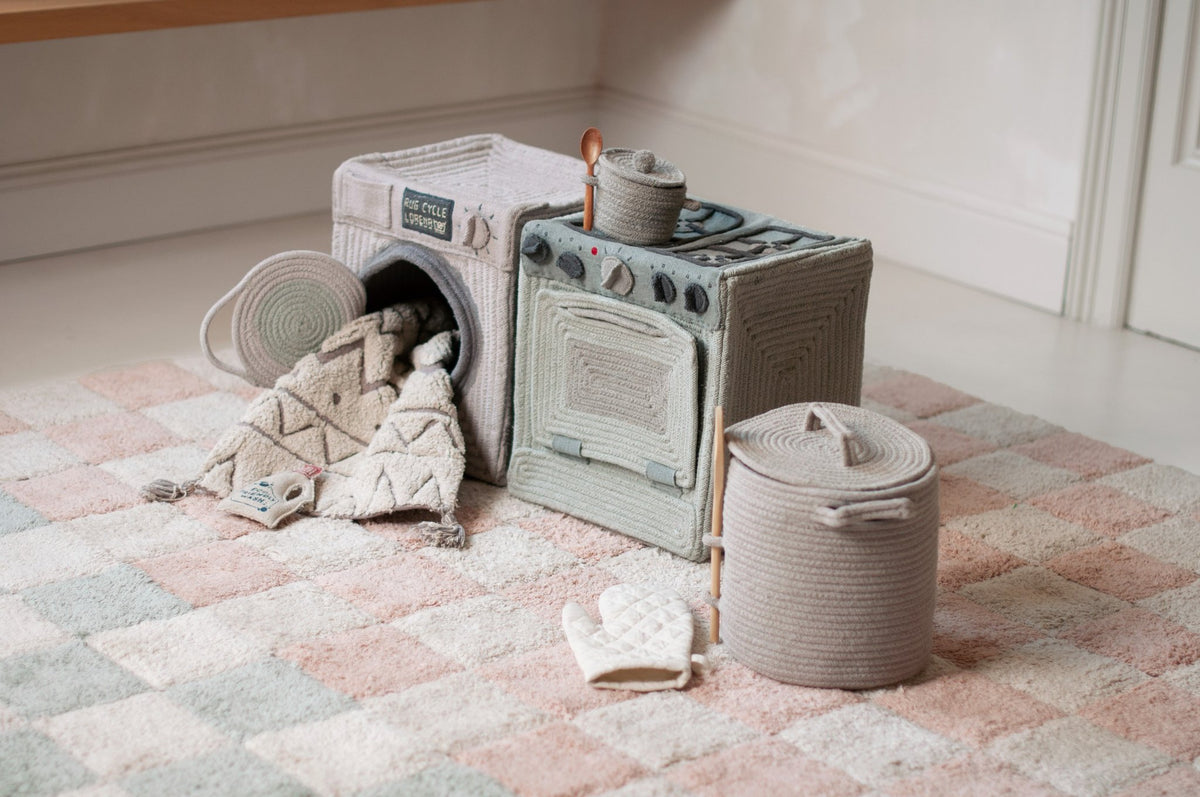 2. Lorena Canals blue sage textile toy stove and washing machine with accessories on checkered rug