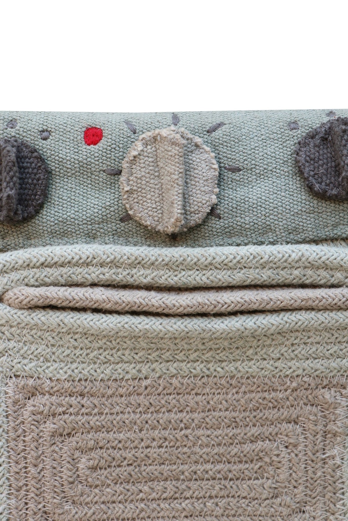 6. Close-up of Lorena Canals textile toy stove control panel with knobs and oven door