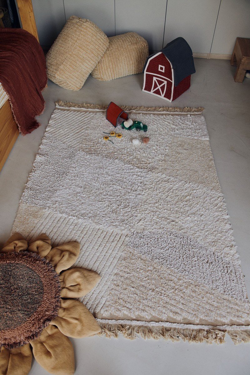 1. Child's room with Lorena Canals cotton play rug in natural colors, featuring farm-themed toys and a barn in the background