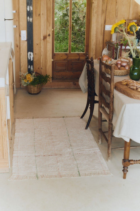 1. Natural cotton rug with multicolor stripes in a cozy dining area with wooden furniture