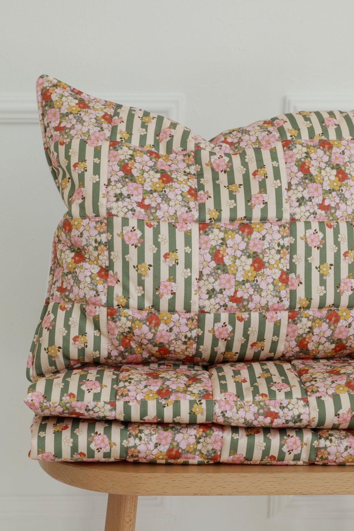 4. Cotton quilted patchwork blanket and pillow set folded on a wooden chair