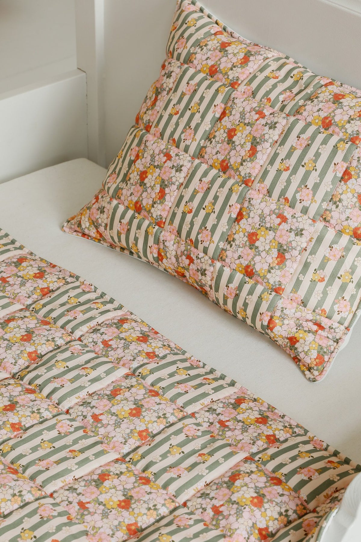 1. Cotton quilted patchwork blanket and pillow set in green garden pattern on a white bed