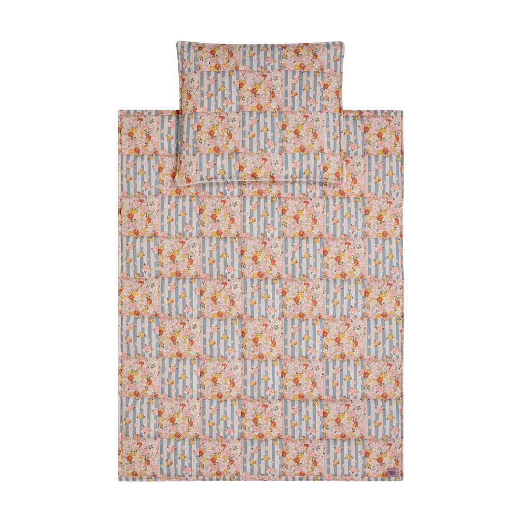 1. Flat lay of Moi Mili cotton quilted patchwork blanket and pillow set in floral and striped pattern