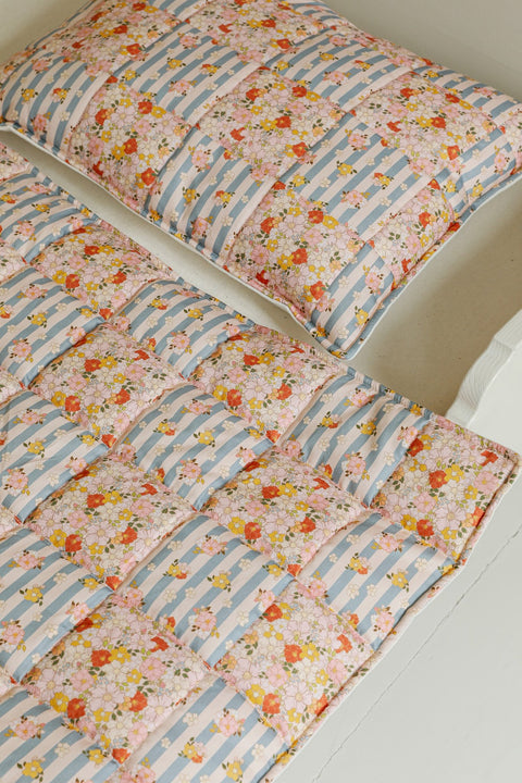 2. Cotton quilted patchwork blanket and pillow set with floral and striped design on bed