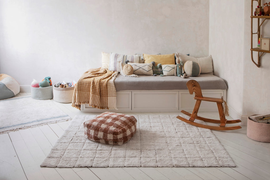 2. Child's room with a daybed and a Lorena Canals toffee-colored mosaic cotton rug on white wooden floor