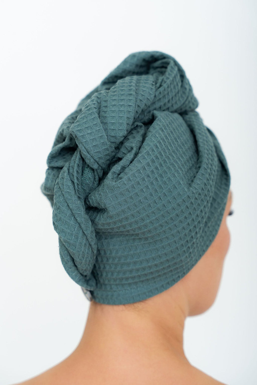 8. Woman in profile wearing green cotton waffle hair towel turban