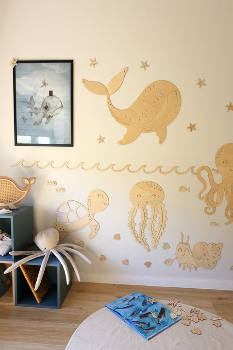 2. Playful ocean-themed wooden wall decorations in a child's room featuring a whale, turtle, and crab