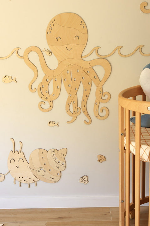 3. Wooden octopus and crab wall decorations in a nursery setting with a crib