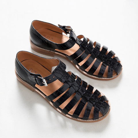 2. Studio shot of Daz Studio's black croc fisherman sandals, highlighting strap-covered front and durable leather sole