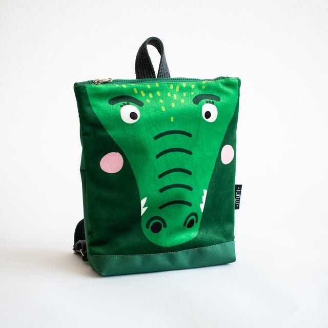5. Studio shot of Muni crocodile backpack showing front design and velvet fabric