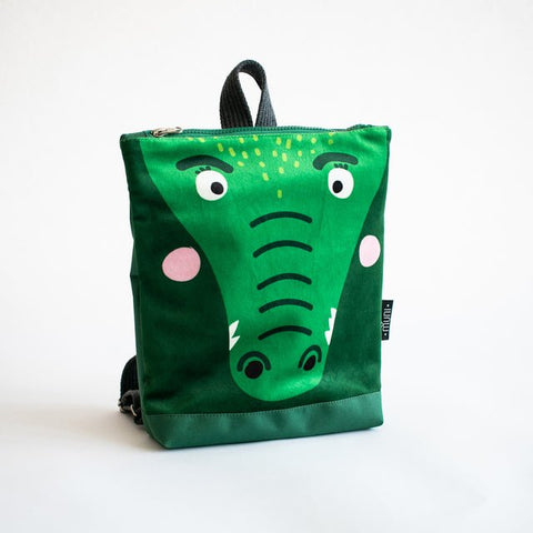 5. Studio shot of Muni crocodile backpack showing front design and velvet fabric