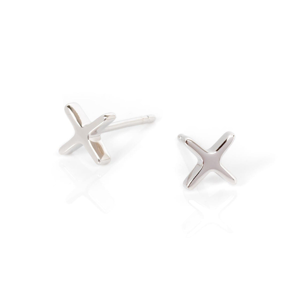 3. Pair of silver Crux earrings in cross shape on white background