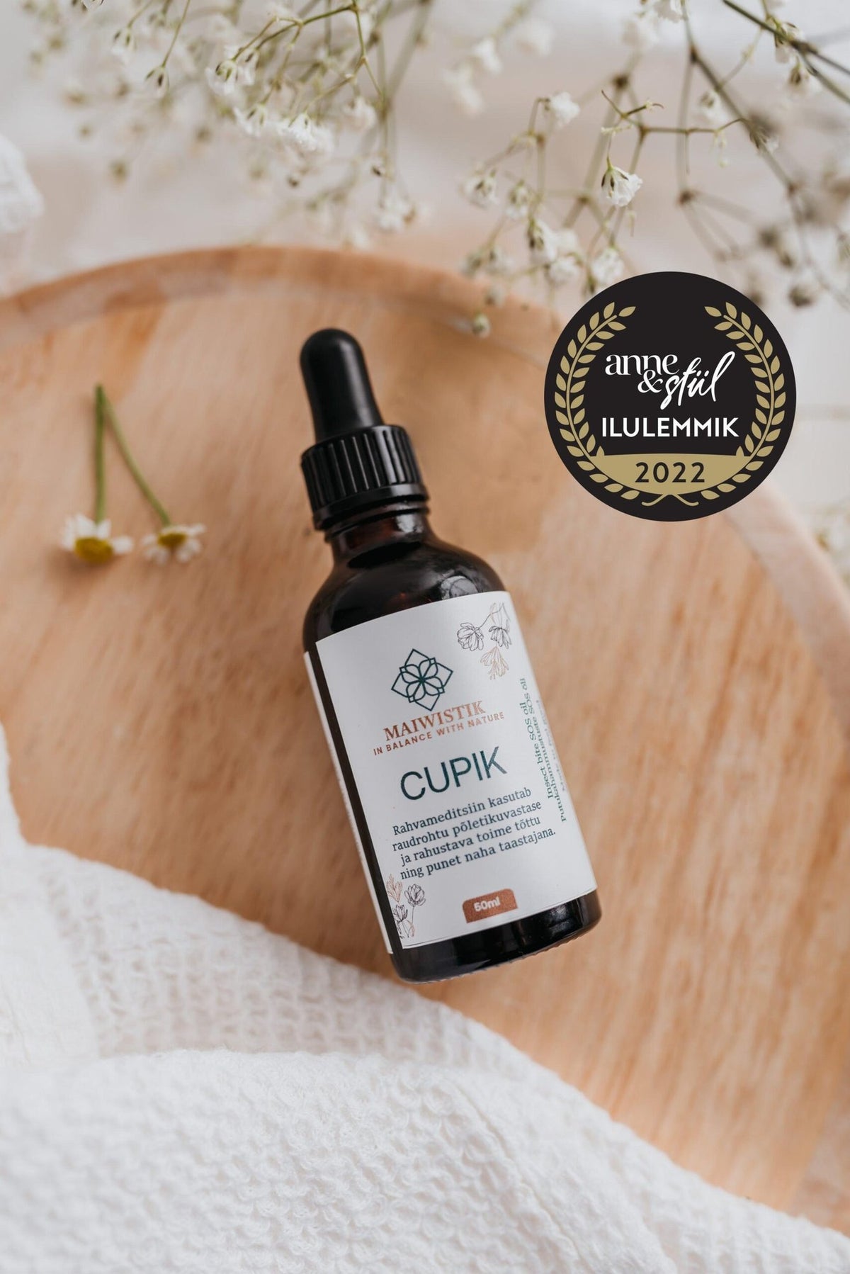 3. CUPIK Oregano and Yarrow SOS Oil by MaiWistik held by a woman, emphasizing natural skincare product