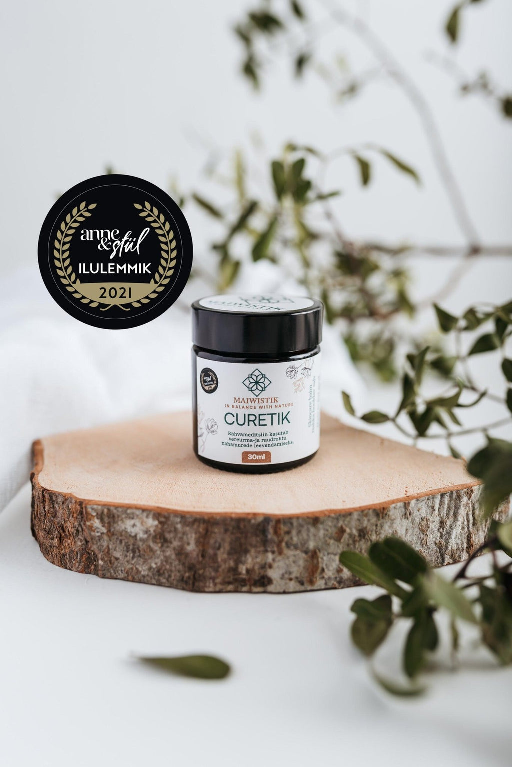 1. MaiWistik CURETIK Deep Moisturizing Ointment 30ml displayed on wooden slab with award badge, surrounded by greenery
