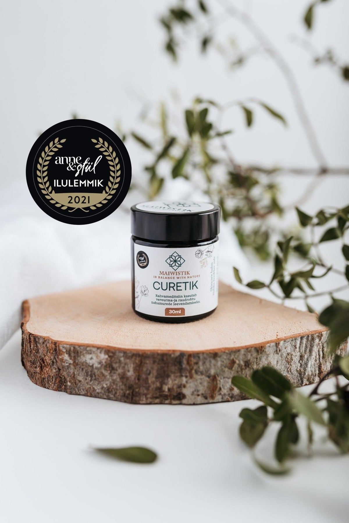 1. MaiWistik CURETIK Deep Moisturizing Ointment 30ml displayed on wooden slab with award badge, surrounded by greenery