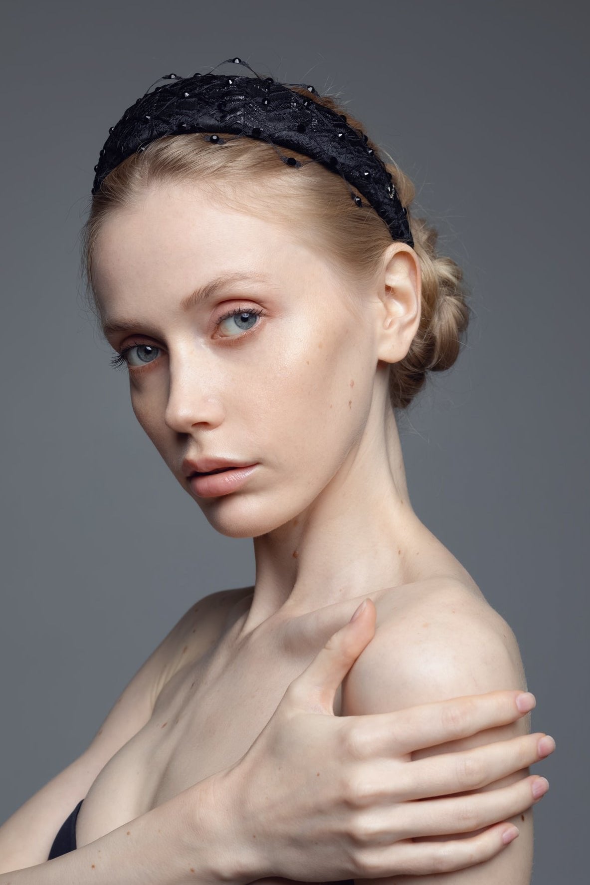 2. Elegant Charlize headband with Swarovski crystals and honeycomb veil by Eva Oherjus, shown on female model