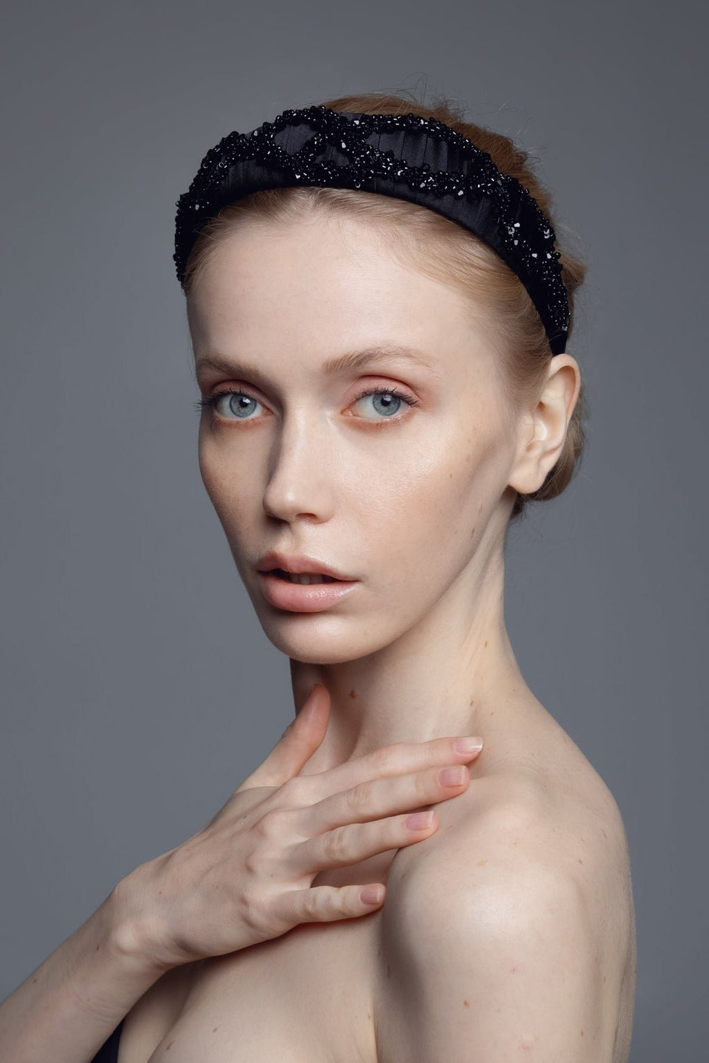 2. Close-up of woman wearing Eva Oherjus Mulberry Silk Beaded Headband Hestia, showcasing hand-beaded embellishments
