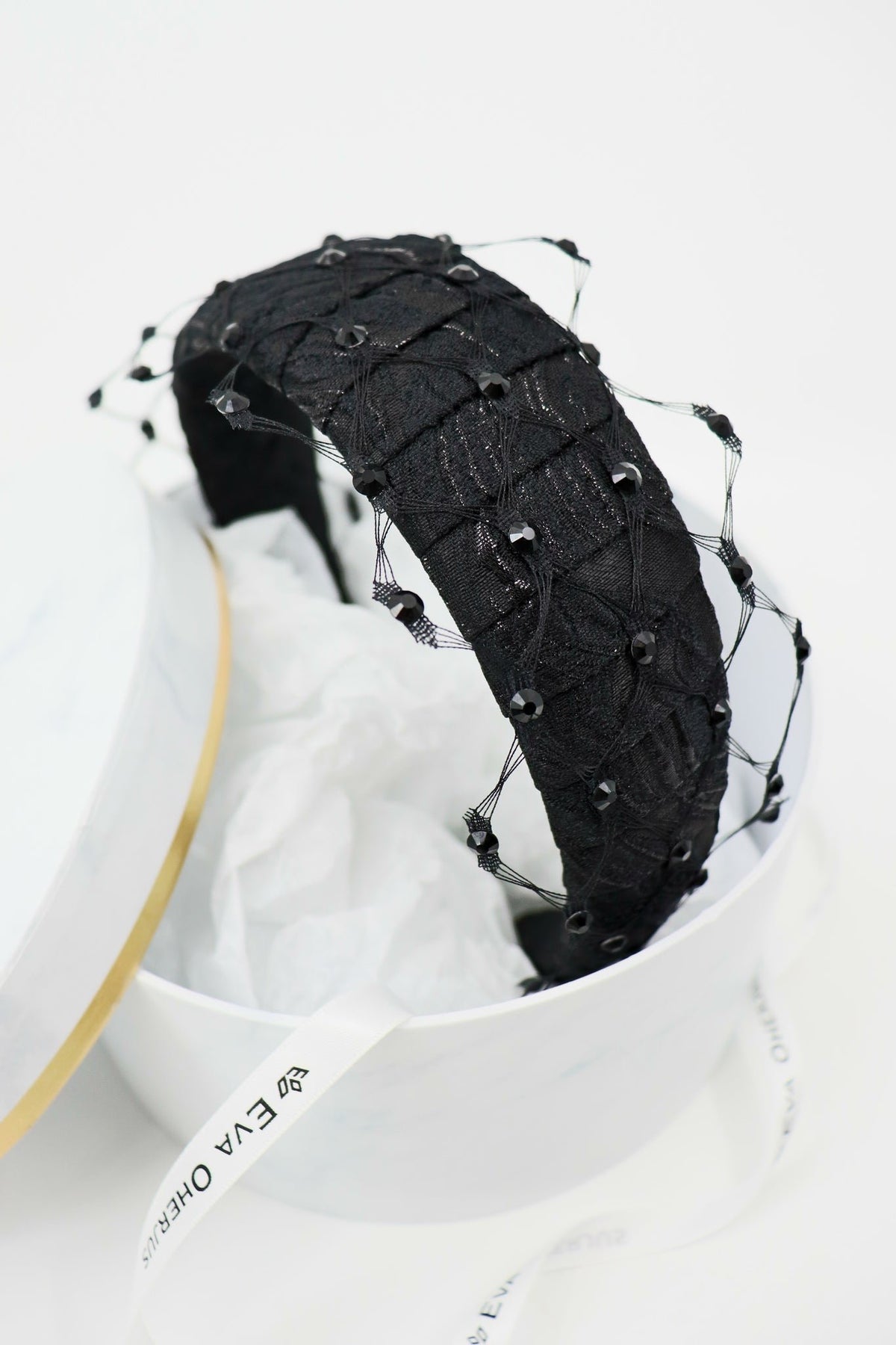 3. Close-up of Charlize headband with Swarovski crystals and honeycomb veil in luxury packaging by Eva Oherjus