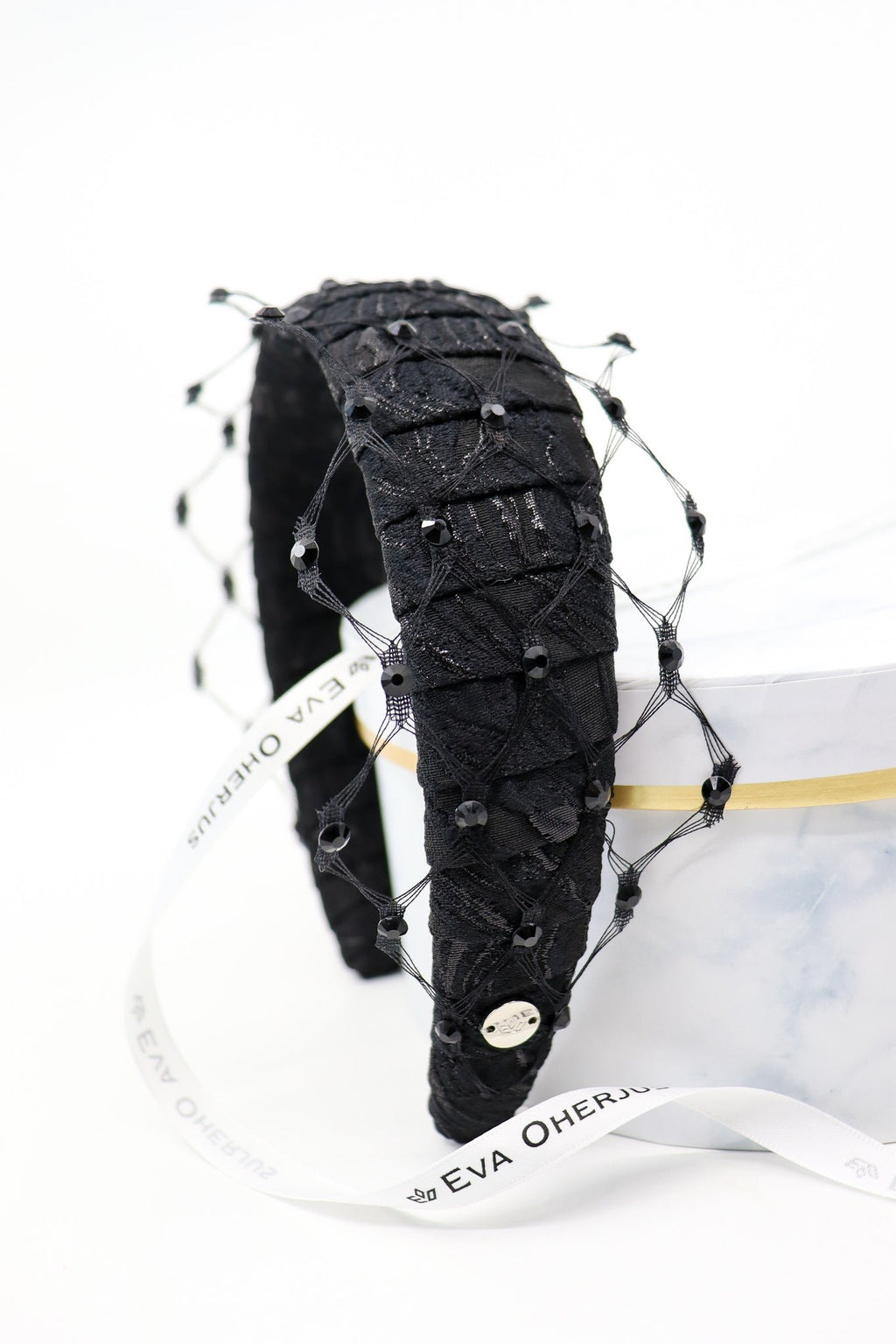 4. Studio shot of Charlize headband with Swarovski crystals and honeycomb veil, featuring Eva Oherjus branding