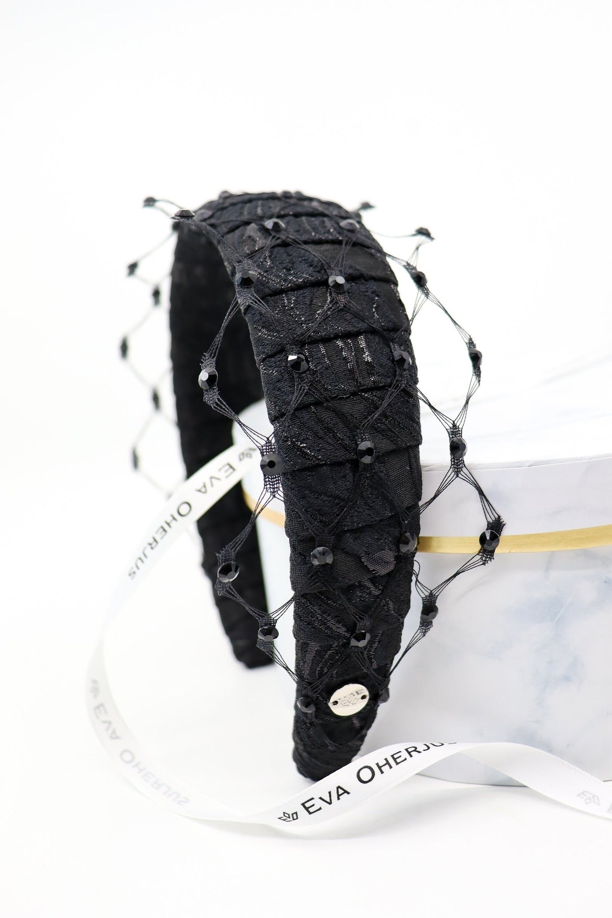 4. Studio shot of Charlize headband with Swarovski crystals and honeycomb veil, featuring Eva Oherjus branding