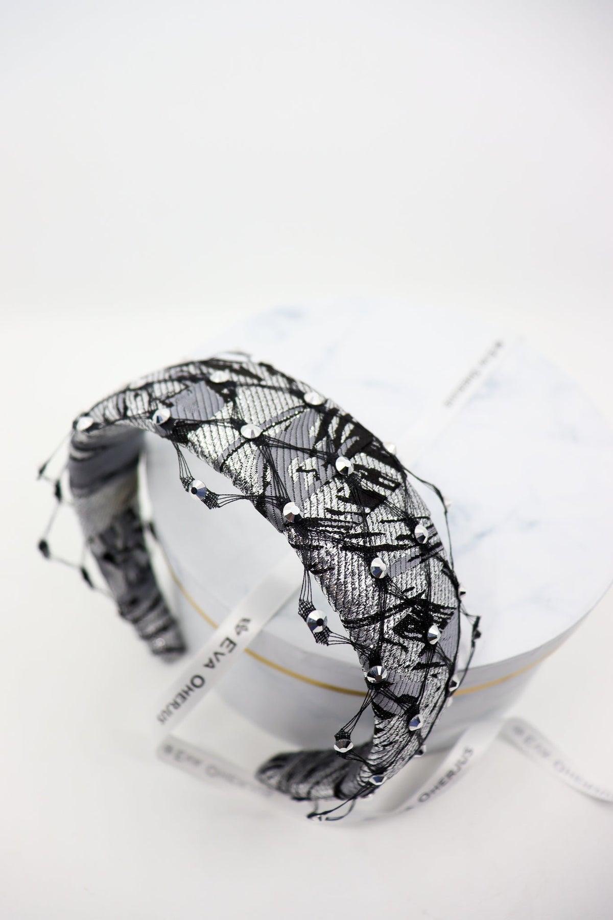 2. Close-up of Fiona headband with honeycomb veil and Swarovski crystals by Eva Oherjus on luxury hat box
