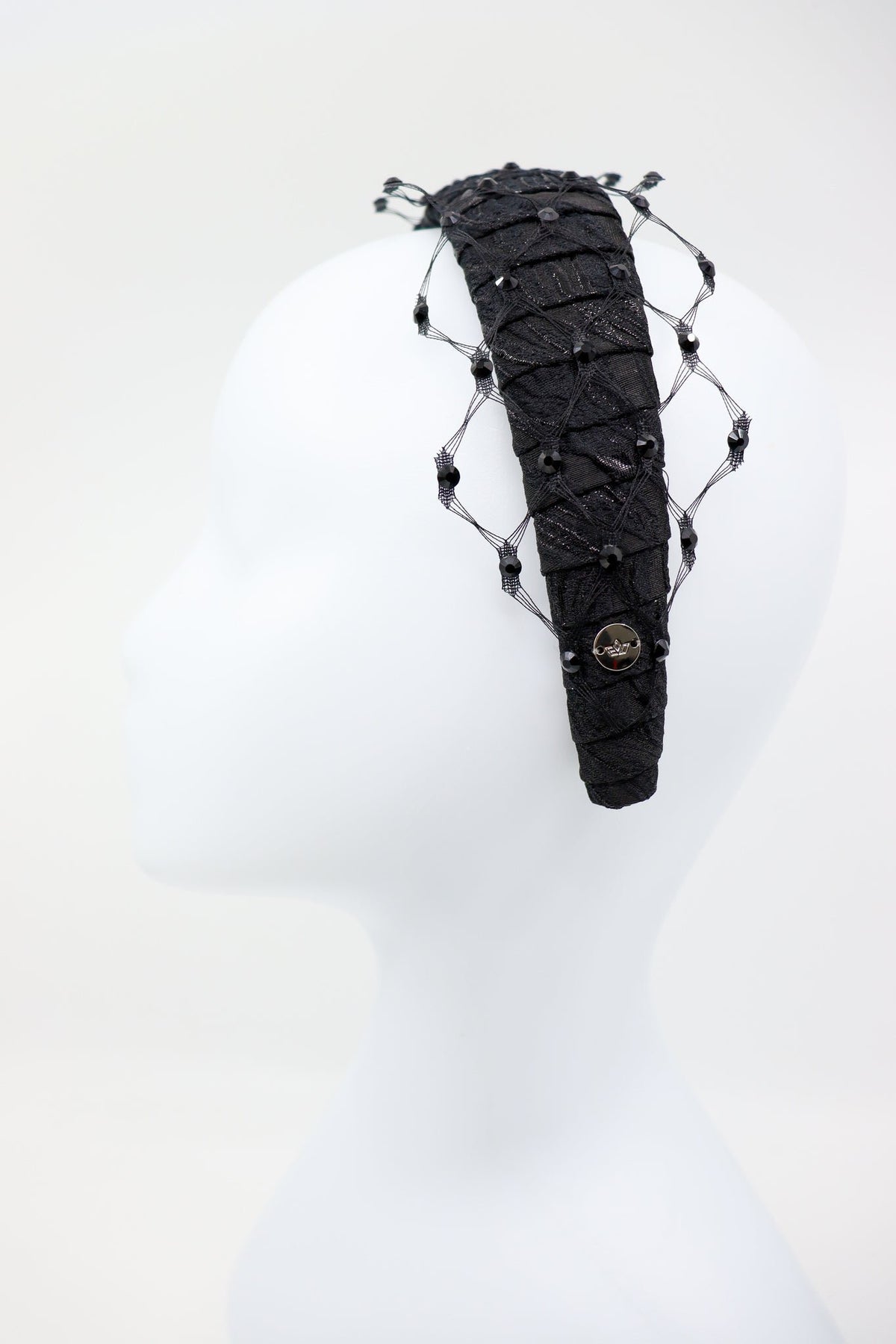 5. Side view of Charlize headband with Swarovski crystals and honeycomb veil by Eva Oherjus on mannequin
