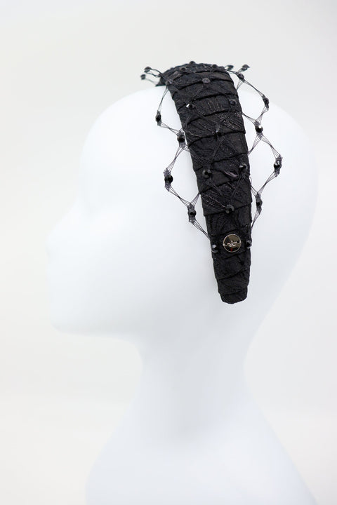 5. Side view of Charlize headband with Swarovski crystals and honeycomb veil by Eva Oherjus on mannequin
