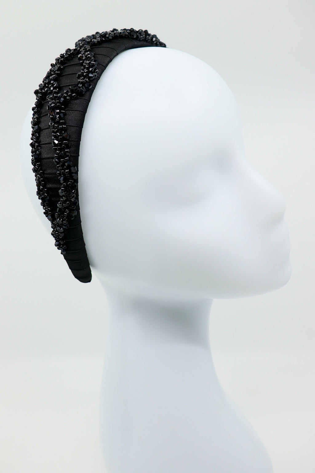 7. Eva Oherjus Mulberry Silk Beaded Headband Hestia on a mannequin, highlighting the elegant design and black shiny beads