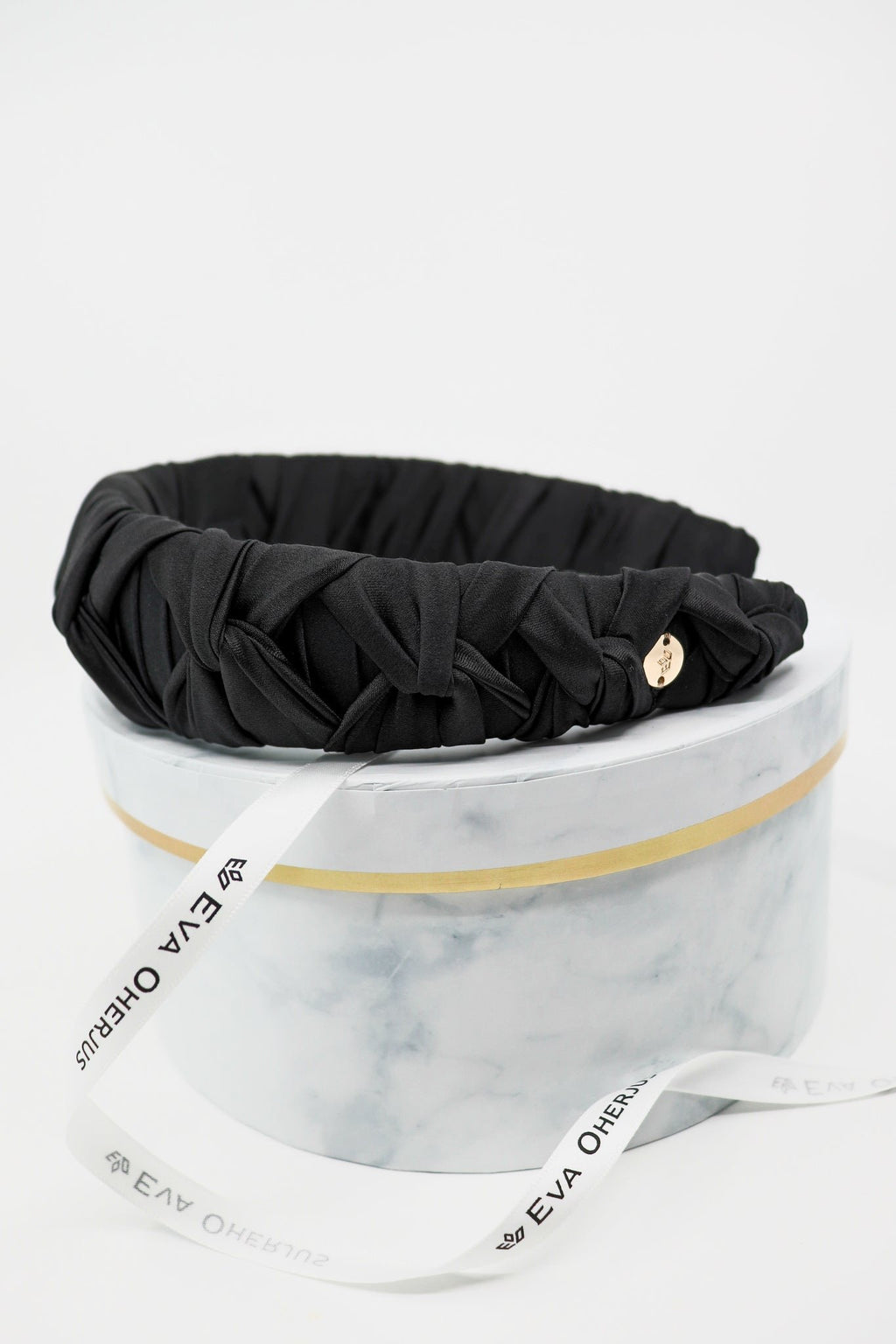 4. Black Mulberry silk knotted headband by Eva Oherjus with gold logo tag on luxury hat box