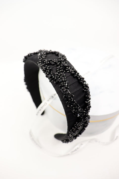 5. Studio shot of Eva Oherjus Mulberry Silk Beaded Headband Hestia on a white background, highlighting black shiny beads and luxury design