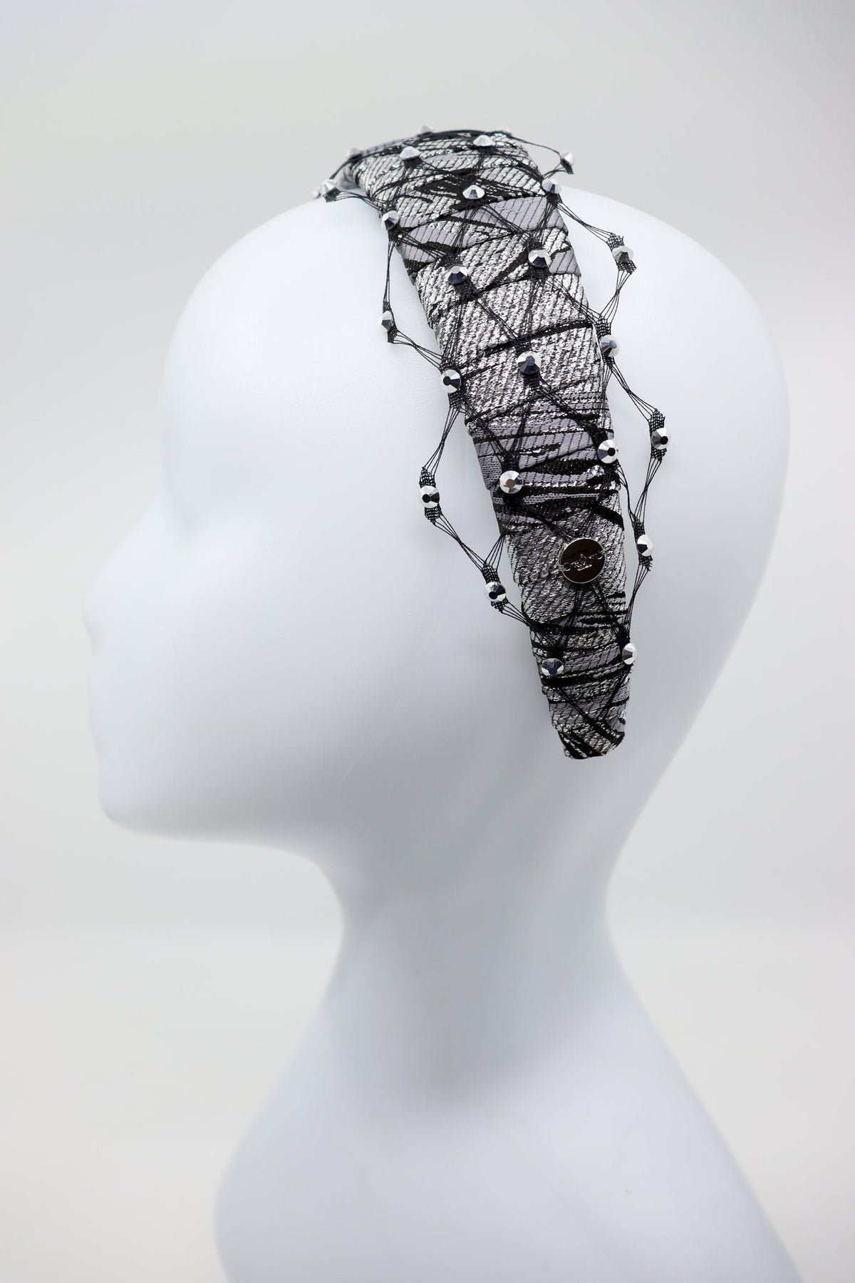 3. Side view of Fiona headband with honeycomb veil and Swarovski crystals by Eva Oherjus on mannequin