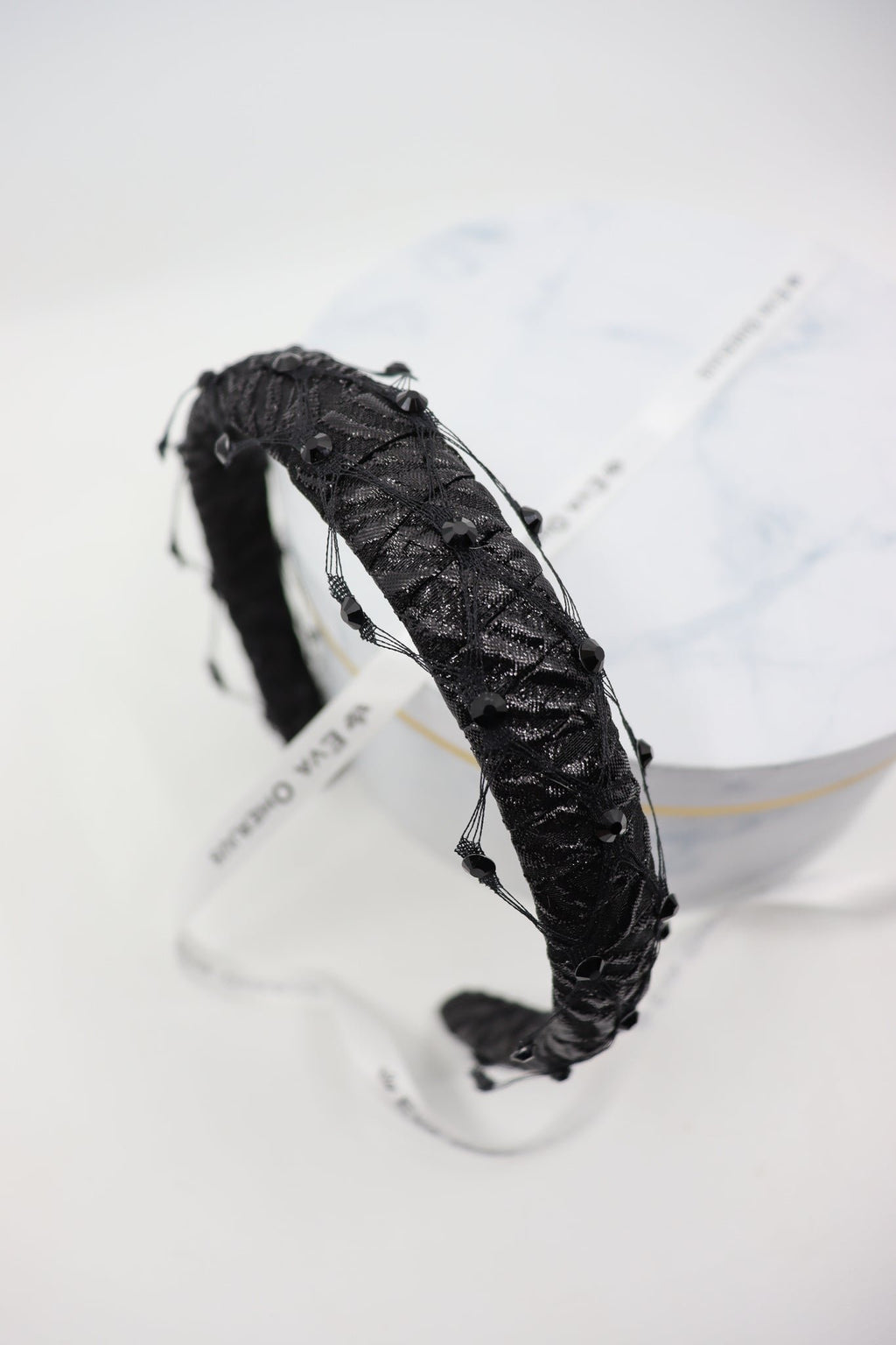 3. Close-up of Slim Headband Naomi showing structural black fabric and Swarovski crystals