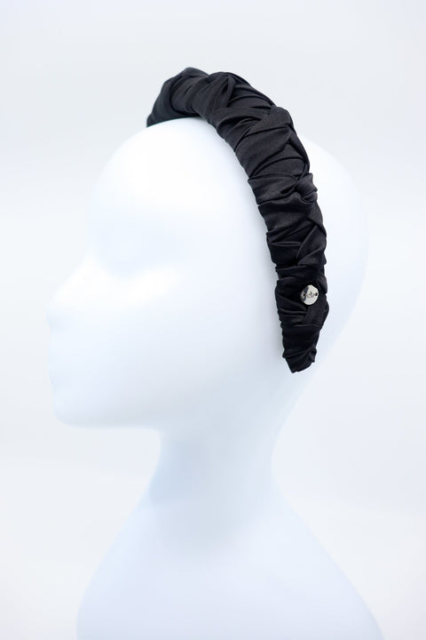 3. Women's black Mulberry silk knotted headband with silver logo tag by Eva Oherjus on mannequin