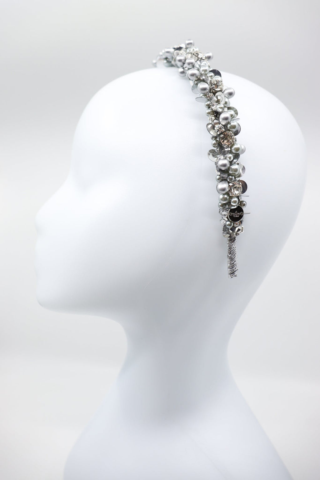3. Side view of Eva Oherjus Selena headband with crystals and pearls on mannequin