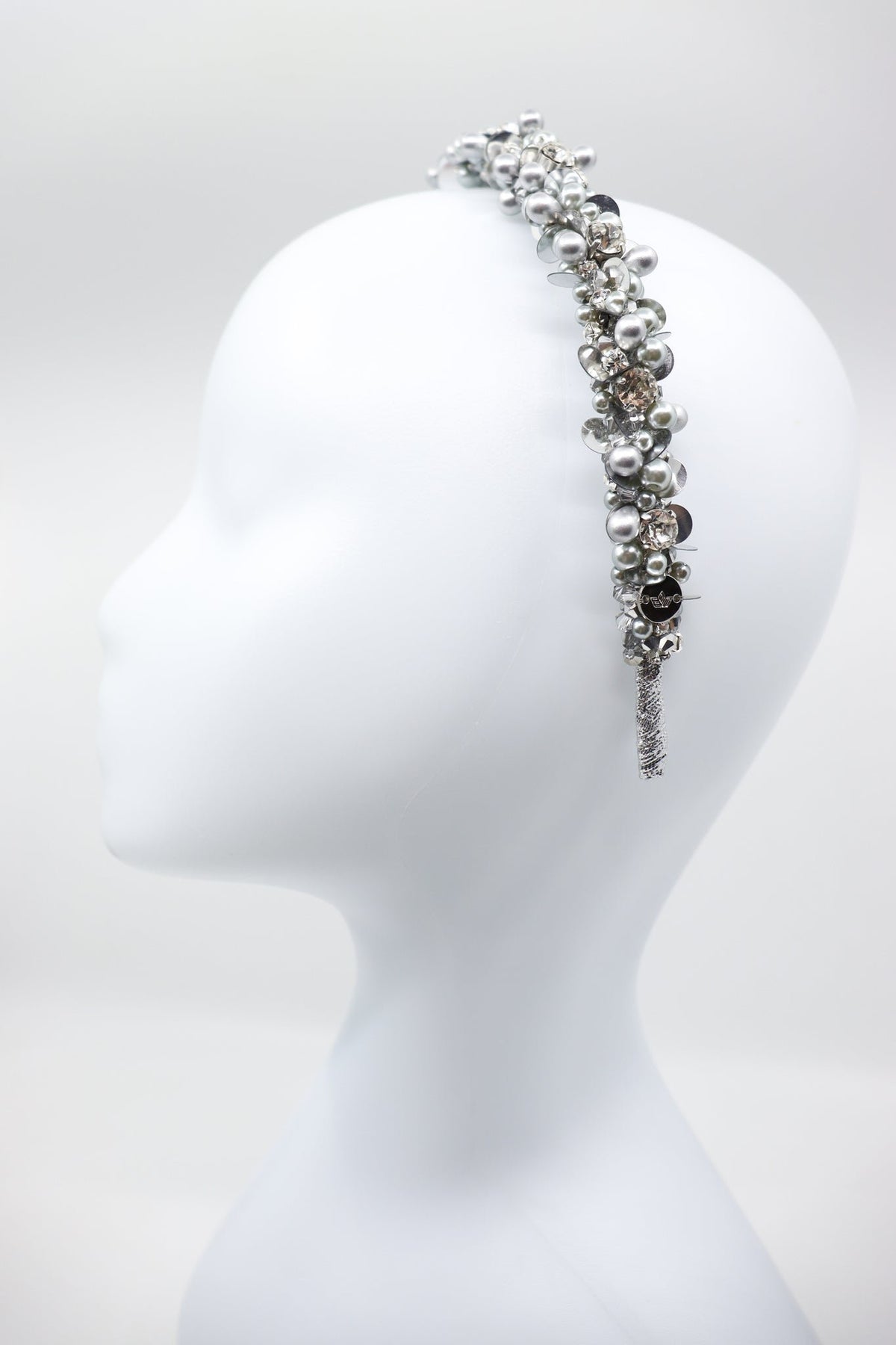 3. Side view of Eva Oherjus Selena headband with crystals and pearls on mannequin