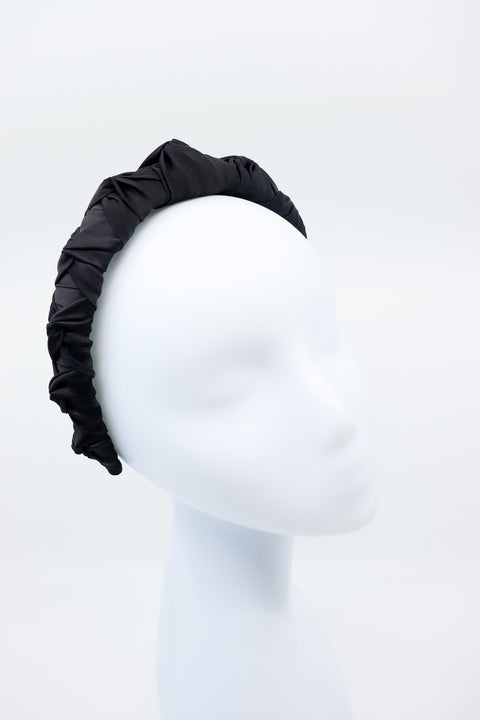 1. Women's black Mulberry silk knotted headband by Eva Oherjus displayed on mannequin in studio