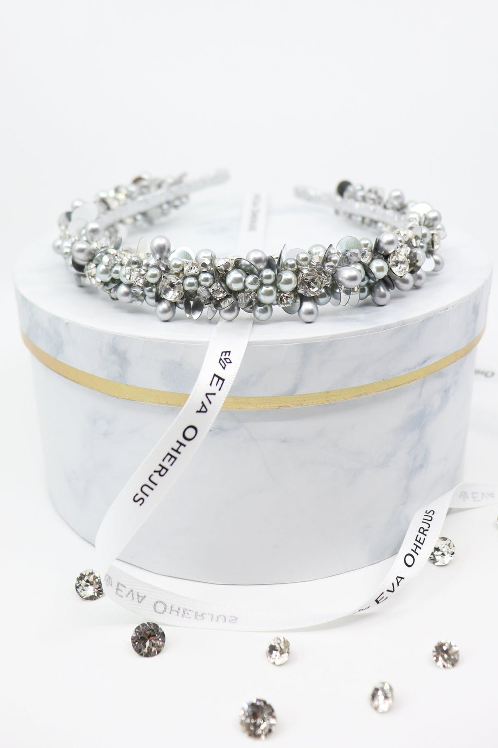2. Eva Oherjus Selena headband adorned with crystals and pearls on marble hat box