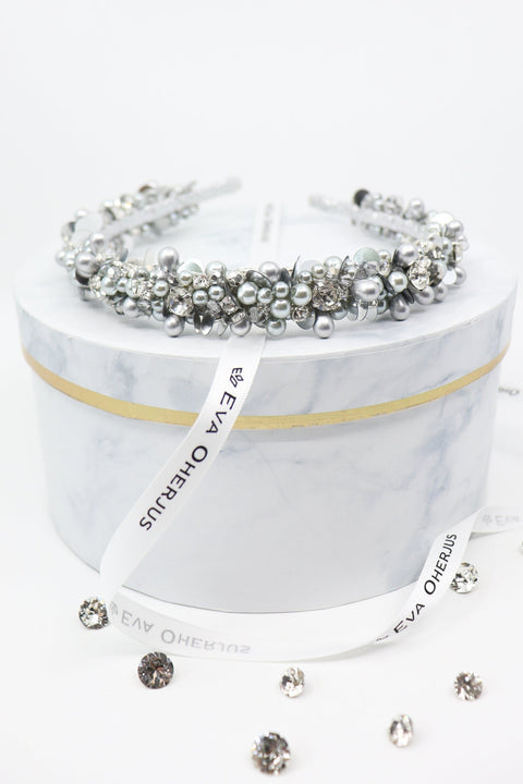 2. Eva Oherjus Selena headband adorned with crystals and pearls on marble hat box