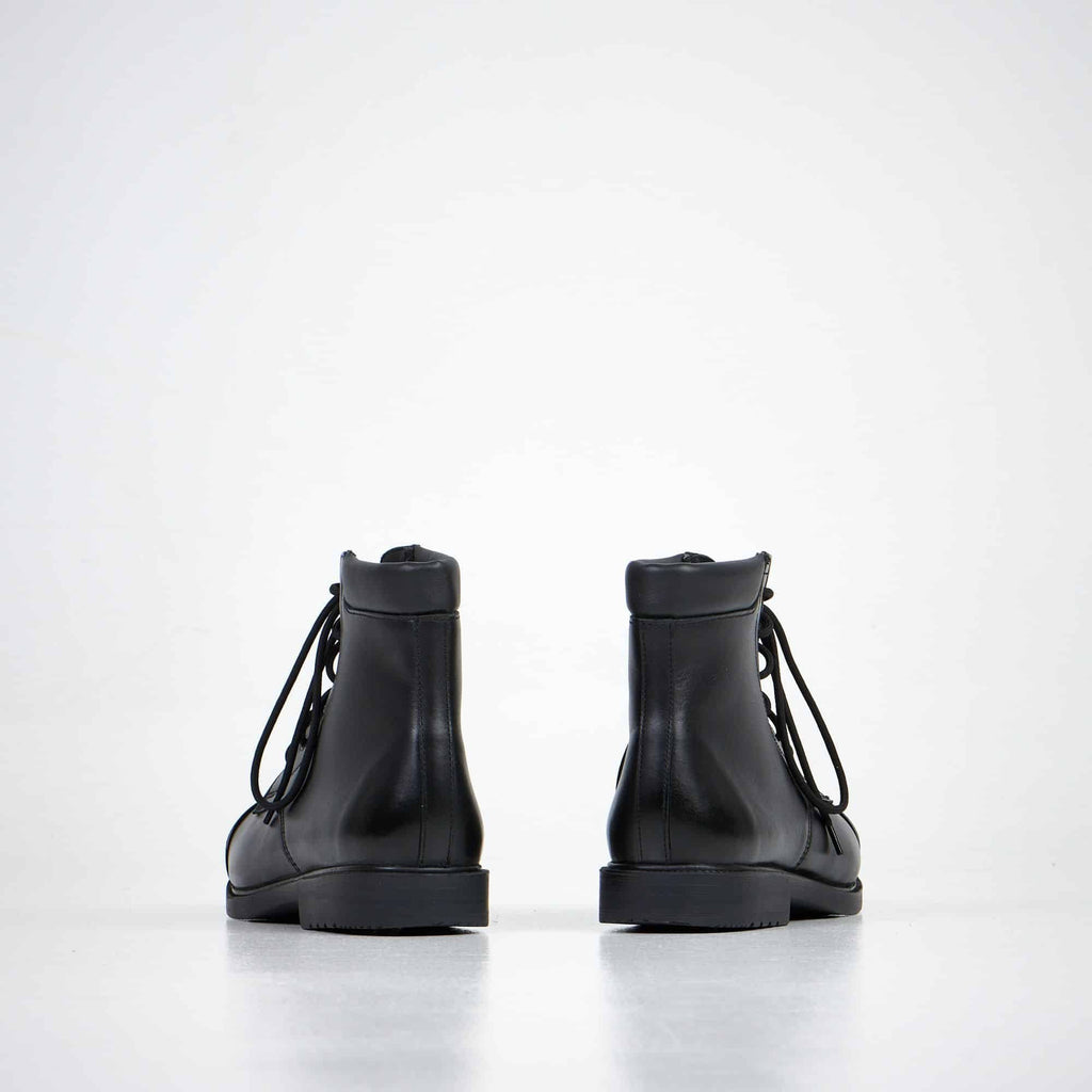 3. Unisex black leather ankle boots by Samelin, back view in studio