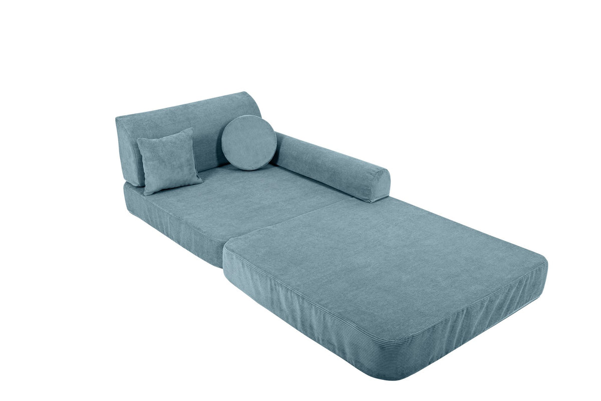 6. Turquoise corduroy children's sofa arranged as a chaise lounge with cylindrical and square cushions on a black background