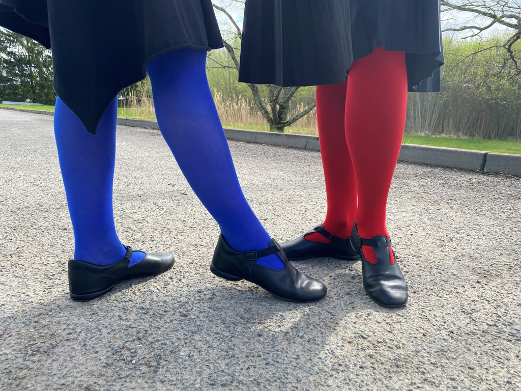 1. Women's black Kergatsi dance shoes by OmaKing worn with colorful tights, shown outdoors