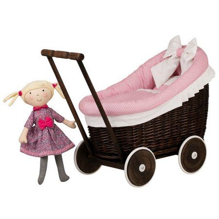 5. Dark painted wicker doll pram with pink bedding next to a doll in a pink dress