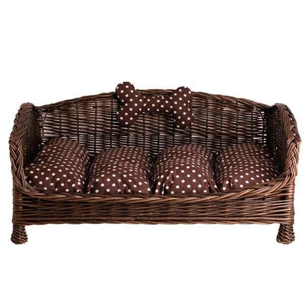 2. Studio shot of dark wicker pet bed with brown polka dot cushion and bone