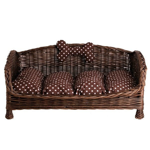 2. Studio shot of dark wicker pet bed with brown polka dot cushion and bone