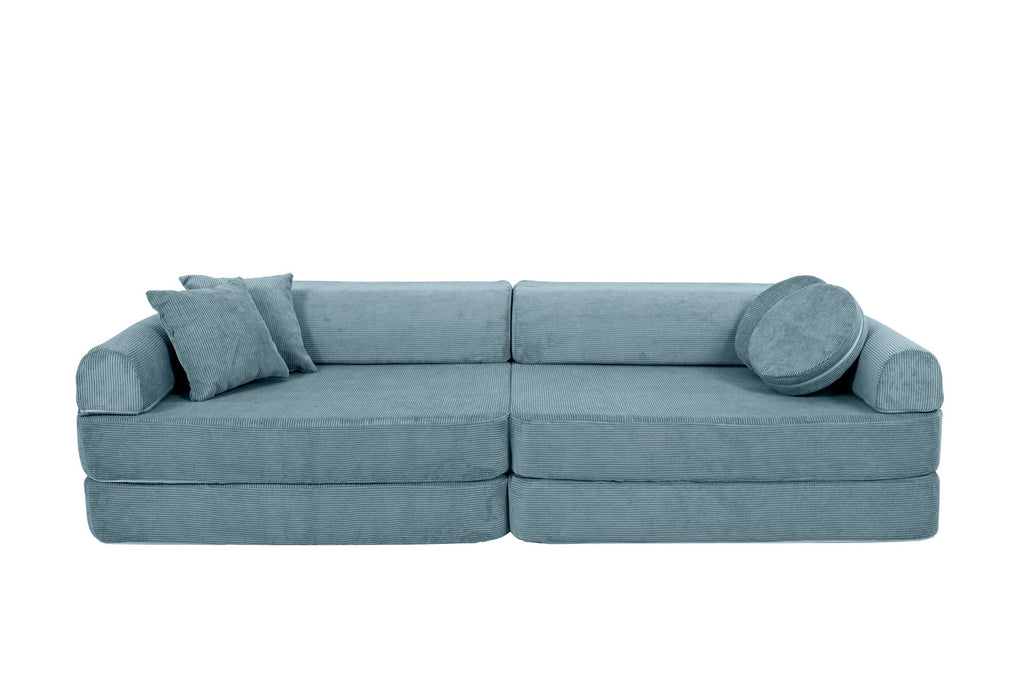 7. Turquoise corduroy children's sofa with cylindrical and square cushions, arranged as a traditional sofa with one cushion on the side on a black background